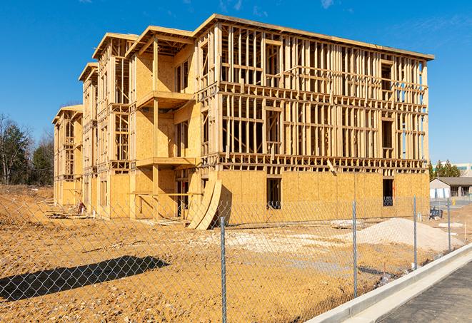 a temporary chain link fence in front of a building under construction, ensuring public safety in Pacifica CA